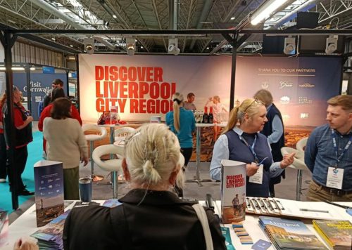 A conference stand with people talking in small groups.