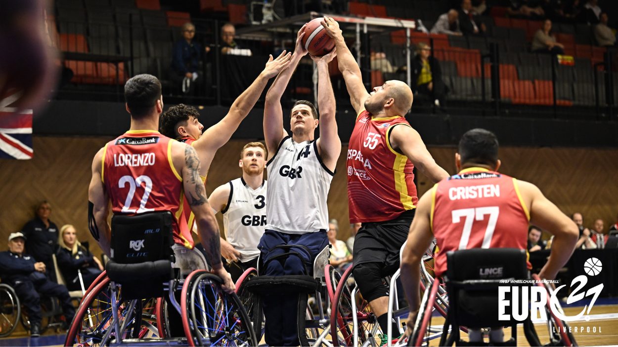 A group of people playing wheelchair basketball.